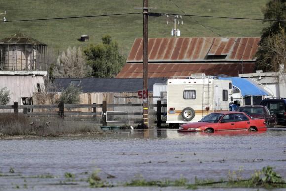 Floodwaters surround a property in Hollister, Calif., on Jan. 11, 2017. (AP Photo/Marcio Jose Sanchez)