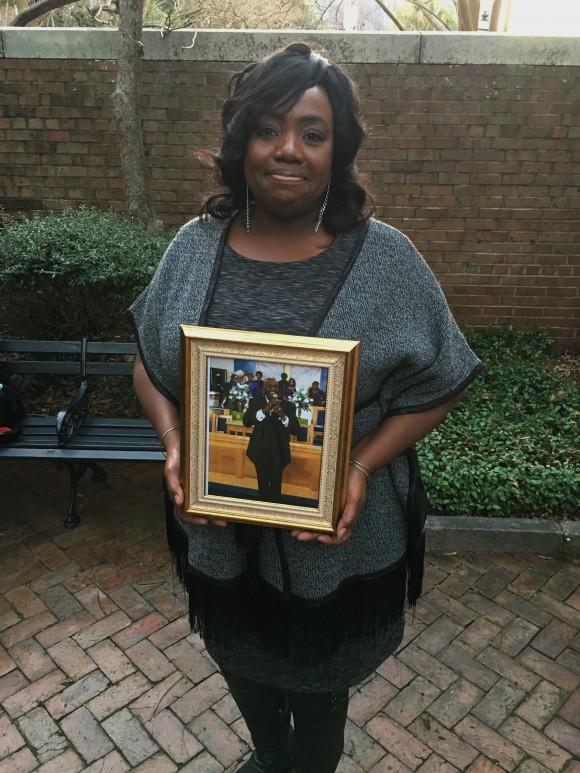 Rose Simmons, the daughter of Rev. Daniel Simmons, Sr., poses with a photograph of her father outside of U.S. District Court in Charleston, S.C., Wednesday, Jan. 11, 2017, hours after Judge Richard Gergel formally confirmed jurors on Tuesday sentenced Dylann Roof to death. (AP Photo/Alex Sanz)