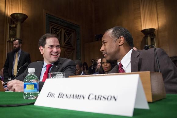 Housing and Urban Development Secretary-designate Ben Carson speaks to Sen. Marco Rubio, R-Fla. on Capitol Hill in Washington prior to the start of Carson's confirmation hearing before the Senate Banking, Housing, and Urban Affairs Committee on Jan. 12, 2017. (AP Photo/Zach Gibson)