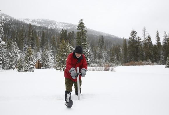 In this file photo, Frank Gehrke, chief of the California Cooperative Snow Surveys Program for the Department of Water Resources, plunges the survey tube into the snowpack as he conducts the first snow survey of the season at Phillips Station near Echo Summit, Calif on Jan. 3 2017. (AP Photo/Rich Pedroncelli)