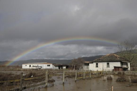 In this file photo, a rainbow is seen over a flooded landscape in Hollister, Calif on Jan. 11 2017.  (AP Photo/Marcio Jose Sanchez)