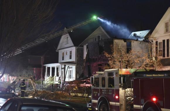 Baltimore City firefighters remain on the scene early Thursday, Jan. 12, 2017, after a fire on Springwood Avenue in northeast Baltimore. (Jerry Jackson/The Baltimore Sun via AP)
