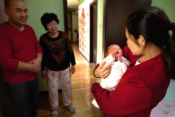 A woman holds a newborn girl at the Antai maternity hospital in Beijing on Jan. 26, 2012. (Ed Jones/AFP/Getty Images)