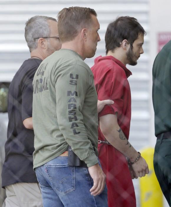 In this file photo, Esteban Santiago, right, accused of fatally shooting several people and wounding multiple others at a crowded Florida airport baggage claim, is returned to Broward County's main jail after his first court appearance in Fort Lauderdale, Fla., on Jan. 9, 2017. (AP Photo/Alan Diaz)