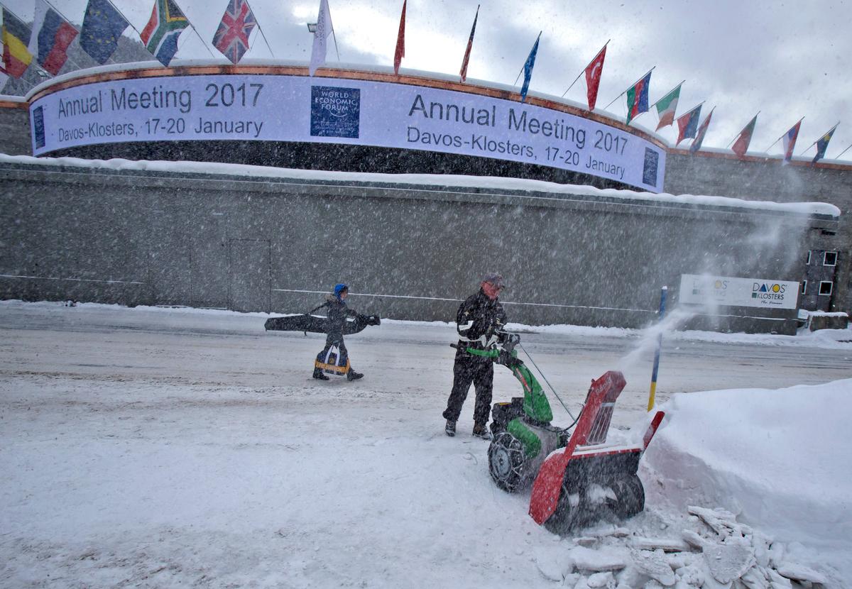 A municipality worker uses a snow blower to clear the area in front of the congress center where the annual meeting, World Economic Forum, will take place in Davos, Switzerland on Jan. 15, 2017. (AP Photo/Michel Euler)