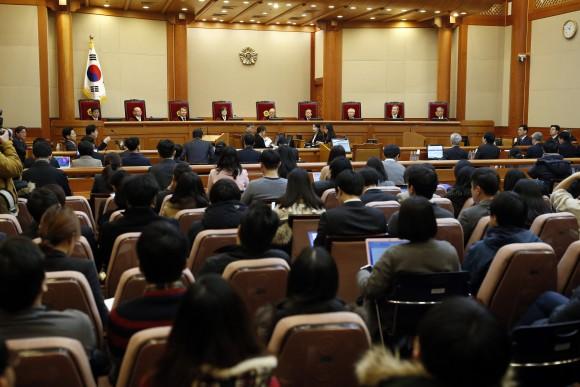 Nine judges of South Korea's Constitutional Court sit during hearing arguments for South Korean President Park Geun-hye's impeachment trial at the Constitutional Court in Seoul, South Korea, on Jan. 16, 2017. (Kim Hong-ji/Pool Photo via AP)