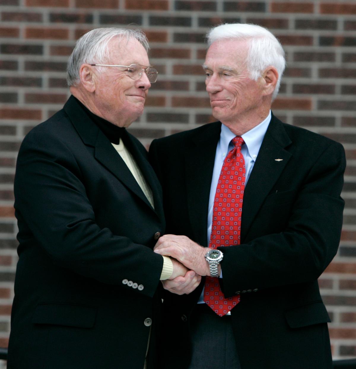 Former astronaut Neil Armstrong (L) is congratulated by fellow ex-astronaut Gene Cernan following the dedication ceremony of the Neil Armstrong Hall of Engineering at Purdue University in West Lafayette, Ind. (AP Photo/Michael Conroy)