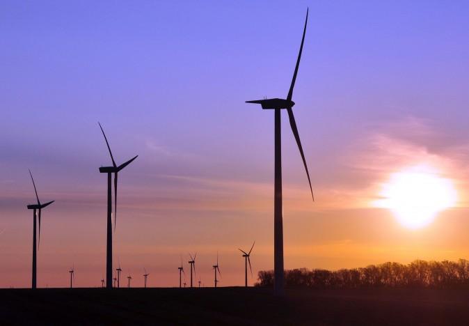 Turbines spin as the sun rises at a wind farm near Toronto, S.D., in 2011. (AP Photo/Dirk Lammers)
