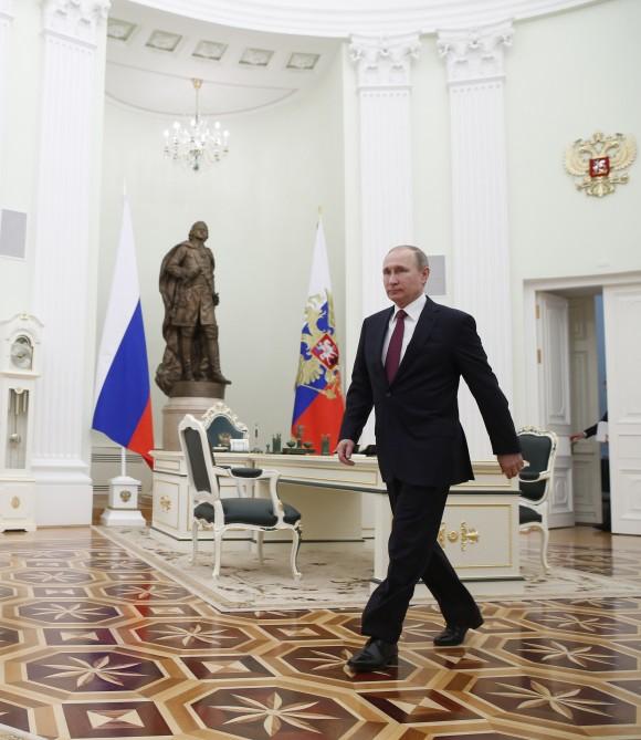 Russian President Vladimir Putin walks to meet with Moldovan President Igor Dodon in Moscow's, Kremlin, Russia on Jan. 17, 2017. Dodson is in Russia on an official visit. (Sergei Ilnitsky/Pool photo via AP)