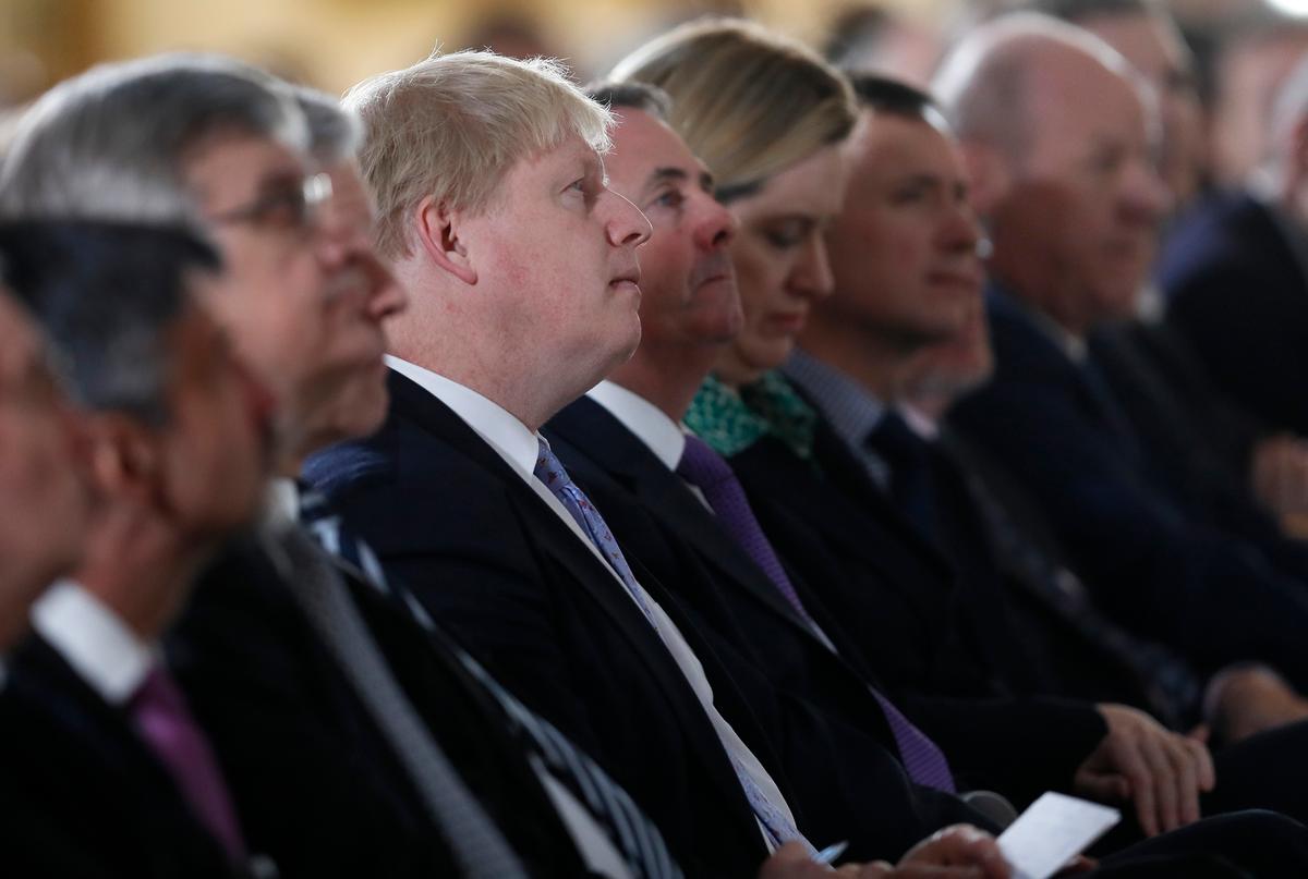 Britain's Foreign Secretary Boris Johnson (C) listens as Prime Minister Theresa May delivers a speech on leaving the European Union at Lancaster House in London on Jan. 17, 2017. (AP Photo/Kirsty Wigglesworth, pool)