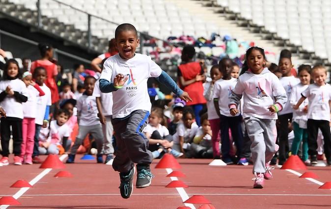 Children run at the Stade de France in Saint-Denis as the IOC Evaluation Commission continues with its visit to Paris, on May 15, 2017, before a vote for the 2024 Summer Olympics. (FRANCK FIFE/AFP/Getty Images)