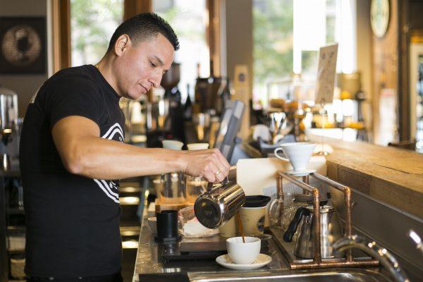 Cesar Jara, coffee supervisor at Brazilia Cafe, makes coffee using an AeroPress, in NoHo, Manhattan, on Oct. 14, 2014. (Samira Bouaou/Epoch Times)