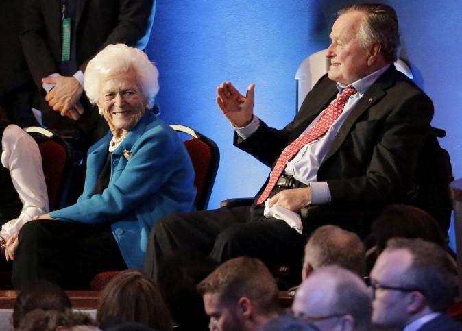 Former President George H. W. Bush (R) and his wife, Barbara, are greeted before a Republican presidential primary debate at The University of Houston in Houston, in this file photo. (AP Photo/David J. Phillip)