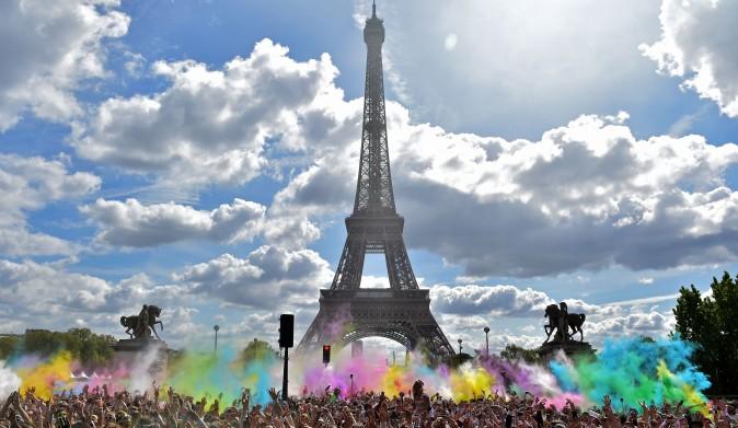 People take part in the Color Run 2017 's edition in front of the Eiffel Tower in Paris on April 16, 2017.<br/>The Color Run is a 5 kilometers paint race without winners nor prizes, where runners are showered with colored powder at stations along the run. (CHRISTOPHE ARCHAMBAULT/AFP/Getty Images)