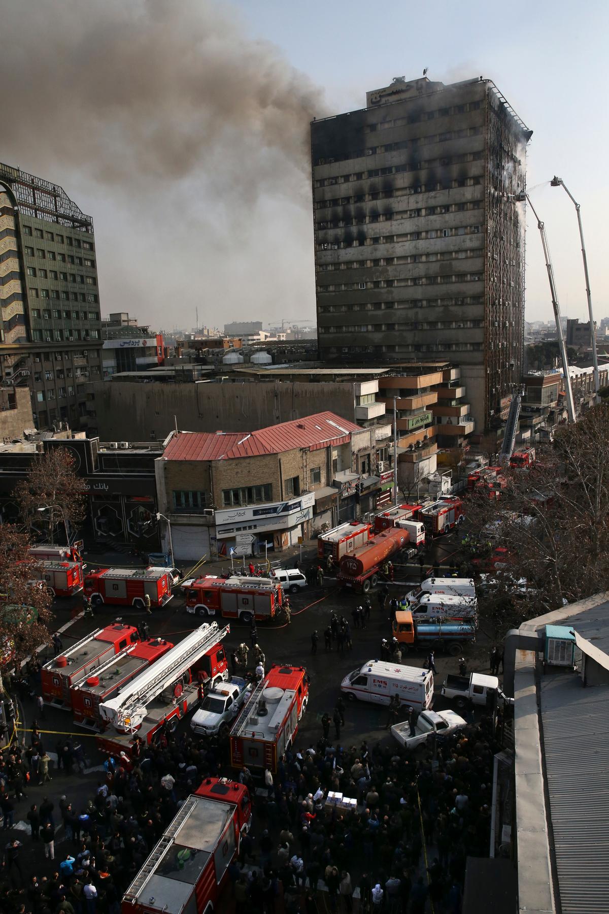 Smoke rises up from the Plasco building where firefighters work to extinguish fire in central Tehran, Iran on Jan. 19, 2017. (AP Photo/Vahid Salemi)