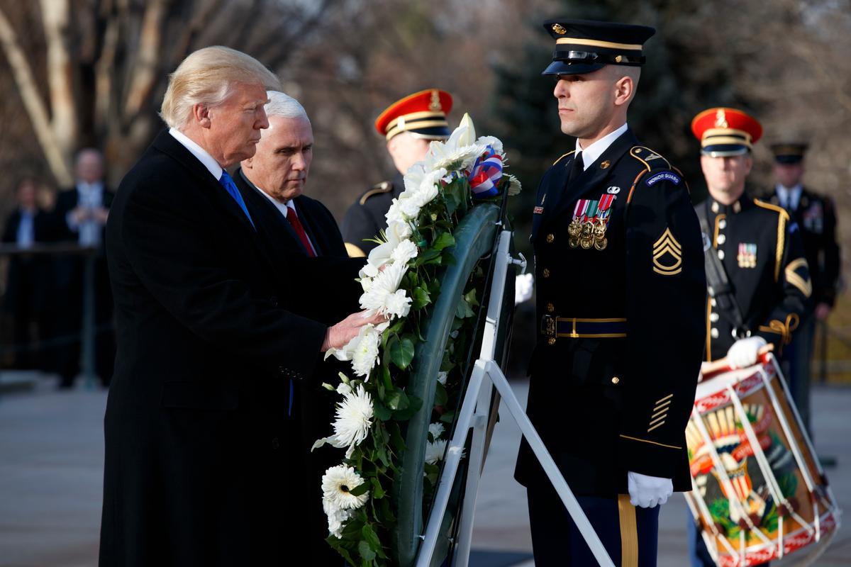 President-elect Donald Trump, accompanied by Vice President-elect Mike Pence places a wreath at the Tomb of the Unknowns at Arlington National Cemetery in Arlington, Va., on Jan. 19, 2017. (AP Photo/Evan Vucci)