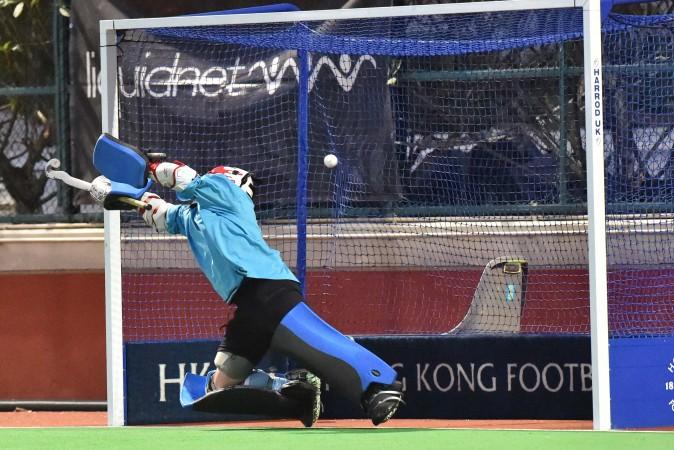 HKFC goalie gets a touch on this penalty stroke by SSSC but the ball flies into the net to pull a goal back to make the score 2-1.(Bill Cox/Epoch Times)