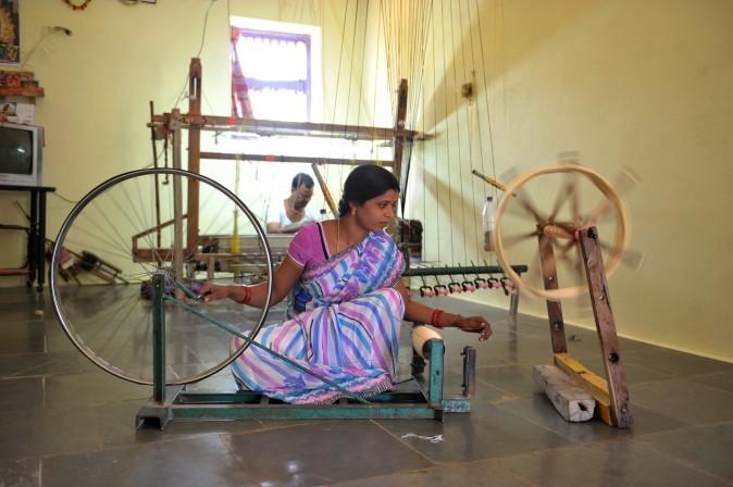 Vanam Pavani works on a charka, or spinning wheel, as she winds weft yarn in her household workshop in Koyalagudem village, in the southern state of Telangana, India, on Jan. 19, 2017. The weavers from the area are known to manufacture exclusive sarees with intricate and distinctive designs. (Noah Seelam/AFP/Getty Images)