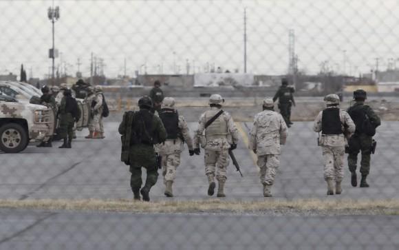 Soldiers walk at the airport after the extradition of drug lord Joaquin "El Chapo" Guzman in Ciudad Juarez, Mexico, Thursday, Jan. 19, 2017.  (AP Photo/Christian Torres)