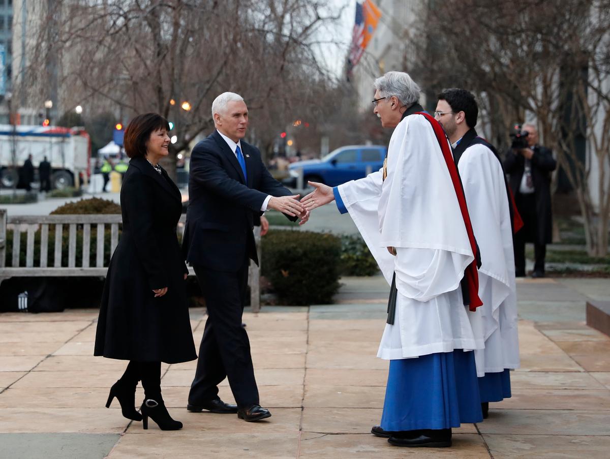 Rev. Luis Leon greets Vice President-elect Mike Pence and his wife Karen as they arrive for a church service at St. John's Episcopal Church across from the White House in Washington on Jan. 20, 2017, on Donald Trump's inauguration day. (AP Photo/Alex Brandon)