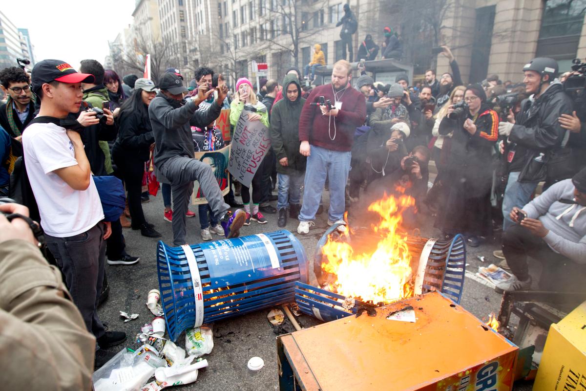 Protesters burn trash cans during the demonstration downtown Washington on Jan. 20, 2017, during the inauguration of President Donald Trump. ( AP Photo/Jose Luis Magana)