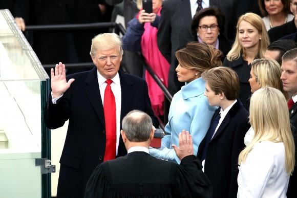Supreme Court Justice John Roberts (2L) administers the oath of office to U.S. President Donald Trump (L) as his wife Melania Trump holds the Bible on the West Front of the U.S. Capitol on January 20, 2017 in Washington, DC. In today's inauguration ceremony Donald J. Trump becomes the 45th president of the United States. (Drew Angerer/Getty Images)