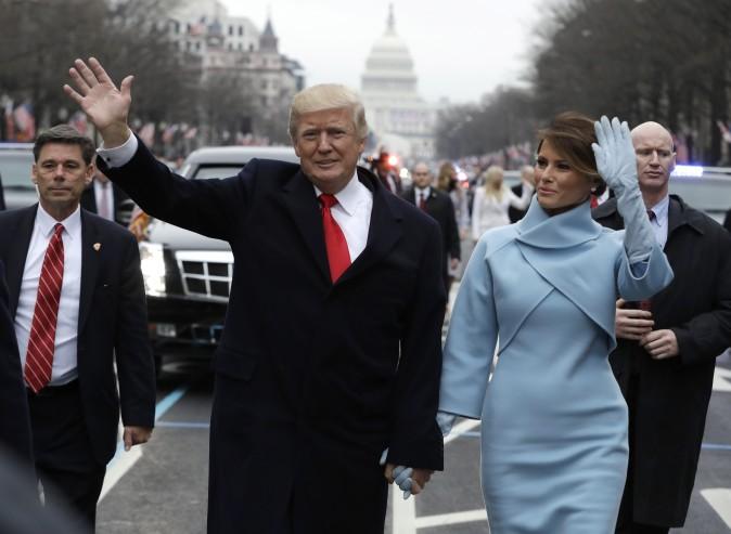 President Donald Trump waves to supporters along the parade route with first lady Melania Trump after being sworn in as the 45th president of the United States in Washington on Jan. 20, 2017. (Evan Vucci - Pool/Getty Images)