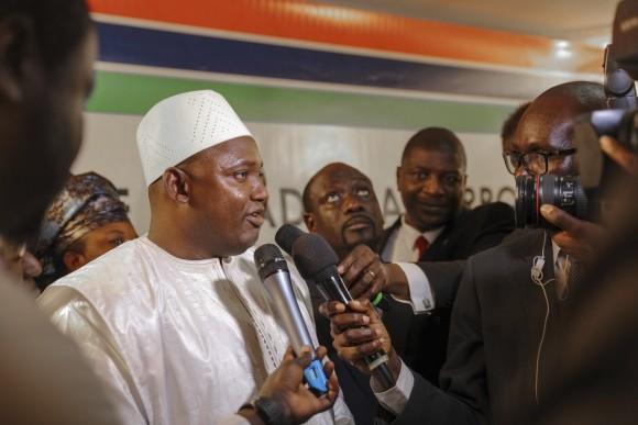 Adama Barrow, left, speaks to the media after he was sworn in as President of Gambia at Gambia's embassy in Dakar, Senegal on Jan 19, 2017. A new Gambian president has been sworn into office in neighboring Senegal, while Gambia's defeated longtime ruler refuses to step down from power, deepening a political crisis in the tiny West African country. (AP Photo)