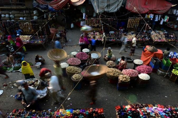 Bangladeshi vendors wait for customers at a wholesale market in Dhaka on Jan. 22, 2017. Dhaka Kawran Bazar is a major business district and wholesale market place in Dhaka. (STR/AFP/Getty Images)