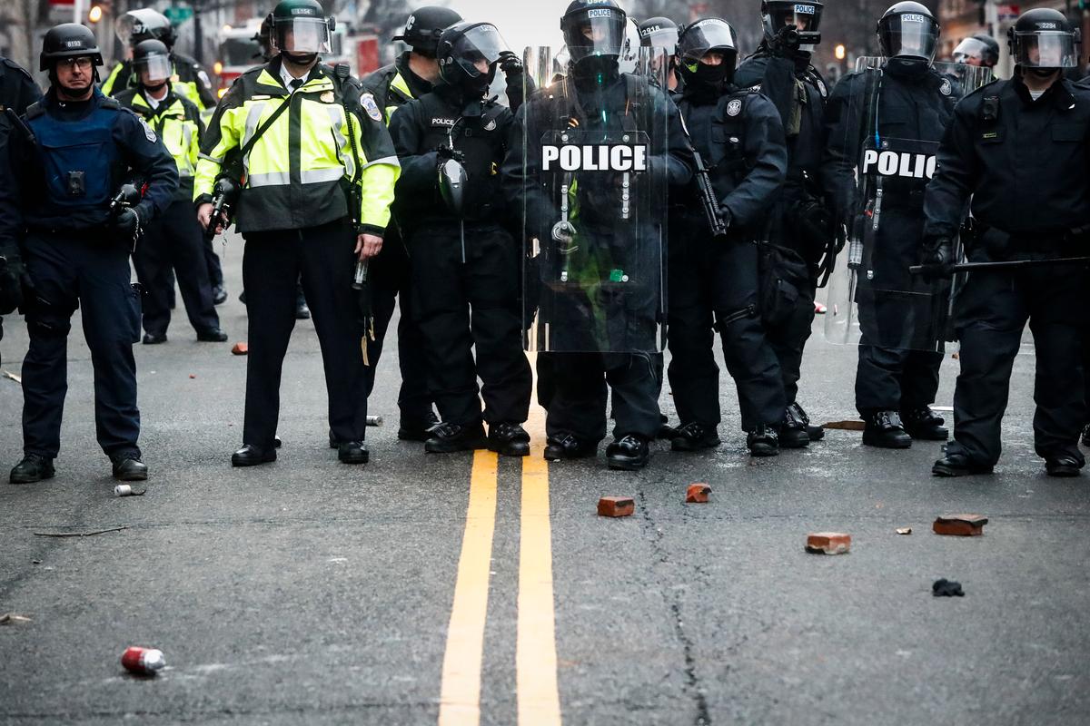 Bricks thrown by protestors rest at the feet of police officers during a demonstration after the inauguration of President Donald Trump in Washington on Jan. 20, 2017. (AP Photo/John Minchillo)