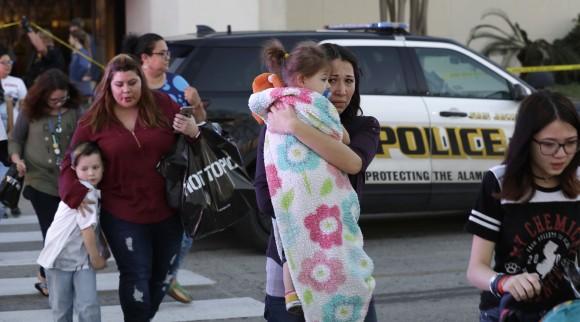 San Antonio police help shoppers exit the Rolling Oaks Mall, Sunday in San Antonio, after a deadly shooting, Jan.22, 2017. (AP Photo/Eric Gay)