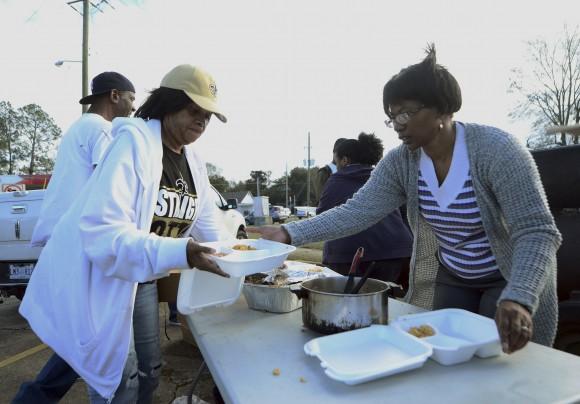Hattiesburg, Miss., volunteers Brenda Dillion and Vanessa Molden put together boxes of food to give out to tornado victims, law enforcement and others in need of food after Saturday's tornado in Hattiesburg on, Jan. 22, 2017. (Susan Broadbridge/Hattiesburg American via AP)