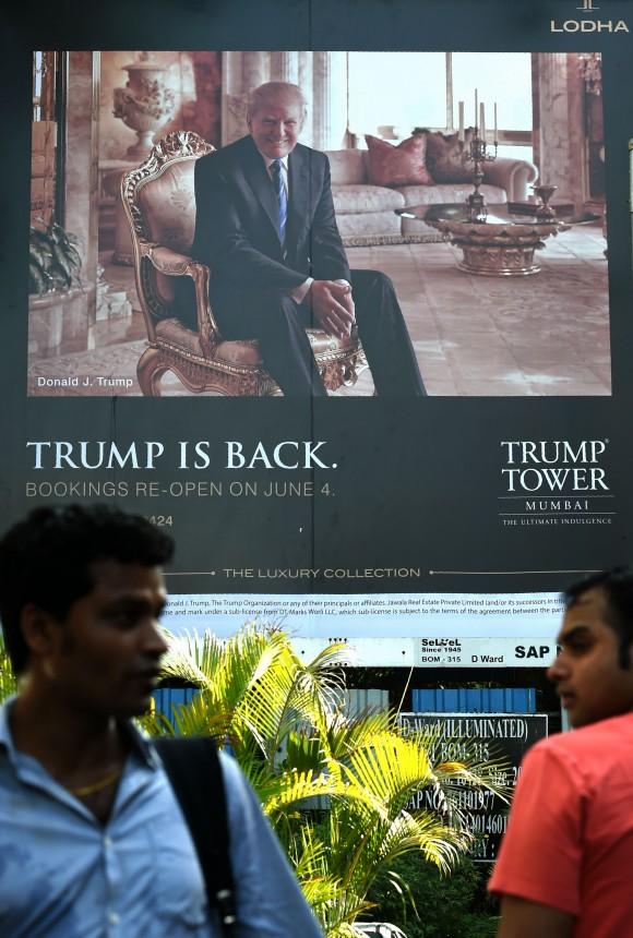 Indian men walk by a billboard for the upcoming luxury residential apartment complex Trump Tower Mumbai, which bears the name of billionaire real estate tycoon and US President Donald Trump, in Mumbai on June 3, 2016. (INDRANIL MUKHERJEE/AFP/Getty Images)