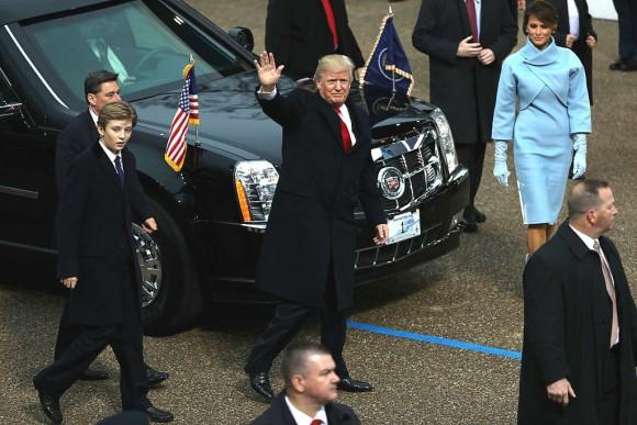 U.S. President Donald Trump (C) waves to supporters as he walks the parade route with first lady Melania Trump (R) and son Barron Trump (L) during the Inaugural Parade in Washington, DC., on Jan. 20, 2017. (Patrick Smith/Getty Images)