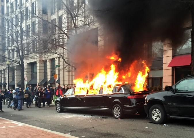 Protesters set a parked limousine on fire in downtown Washington on Jan. 20, 2017, during the inauguration of President Donald Trump. (AP Photo/Juliet Linderman)
