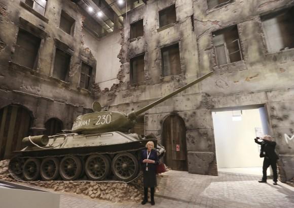 A woman stands in front of an exhibit in the Museum of the Second World War, an ambitious new museum under creation for nine years has opened its doors for a day to historians, museums and reporters in Gdansk, Poland, on Jan. 23, 2017. (AP Photo/Czarek Sokolowski)