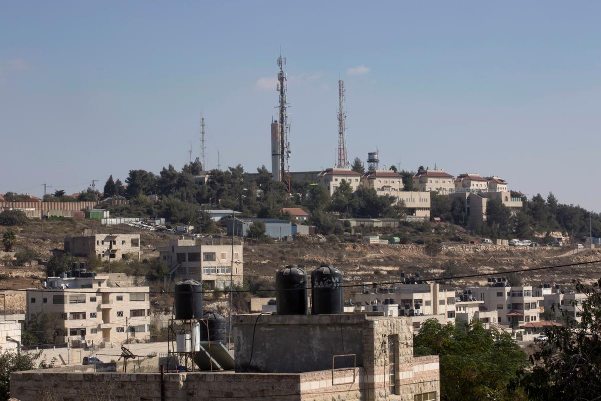Part of the Israeli settlement of Psagot, background, overlooking Palestinian houses, in a suburb of the West Bank city of Ramallah on Oct. 24, 2016. (AP Photo/Nasser Nasser)