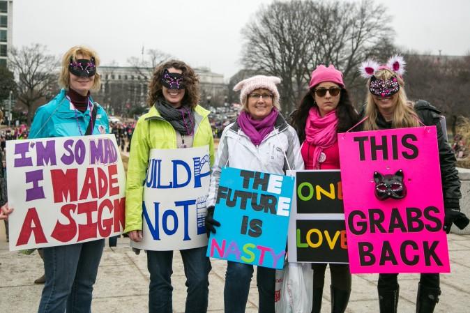 Maura Adamczyk, from Chicago, (C) and her friends, take part in the Women's March on Washington. (Benjamin Chasteen/Epoch Times)
