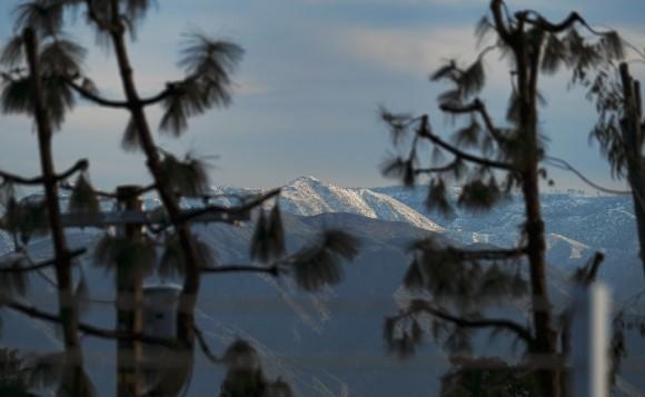 Mountain tops East of Los Angeles are covered with snow seen from Los Angeles, Tuesday, Jan. 24, 2017. (AP Photo/Richard Vogel)