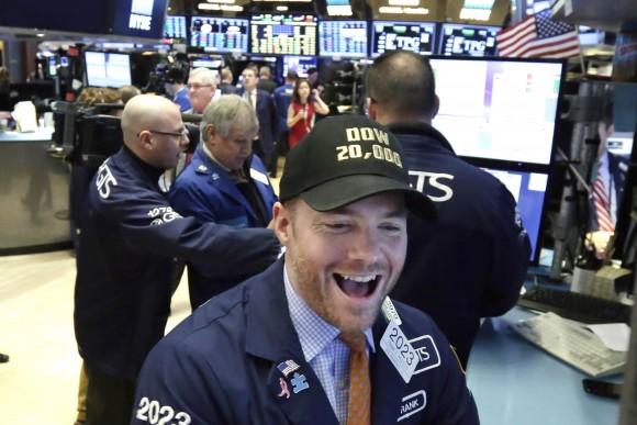 Specialist Frank Masiello wears a Dow 20,000 cap as he works on the floor of the New York Stock Exchange on Jan. 25, 2017. The Dow Jones industrial average is trading over 20,000 points for the first time, the latest milestone in a record-setting drive for the stock market. (AP Photo/Richard Drew)