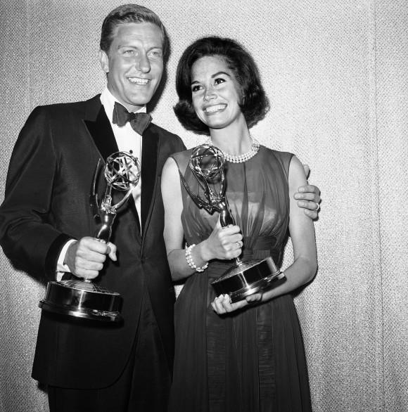 Dick Van Dyke, left, and Mary Tyler Moore, co-stars of "The Dick Van Dyke Show" backstage at the Palladium with their Emmys for best actor and actress in a series at the Television Academy's 16th annual awards show, in Los Angeles on May 25, 1964. (AP Photo, File)