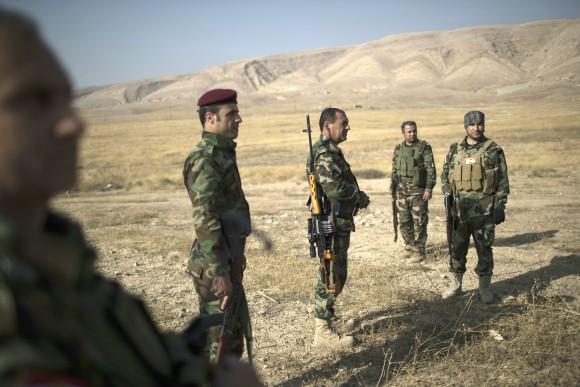 Kurdish Peshmerga fighters gather near a frontline during fighting with ISIS terrorists in Bashiqa, east of Mosul, Iraq, on Nov. 8. (AP Photo/Felipe Dana)