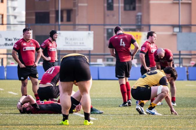 Players gasp for air at the end of the HKRU Premiership game between Borrelli Walsh USRC Tigers (Yellow) and Societe Generale Valley at King's Park on Saturday Jan 21, 2017. (Dan Marchant)