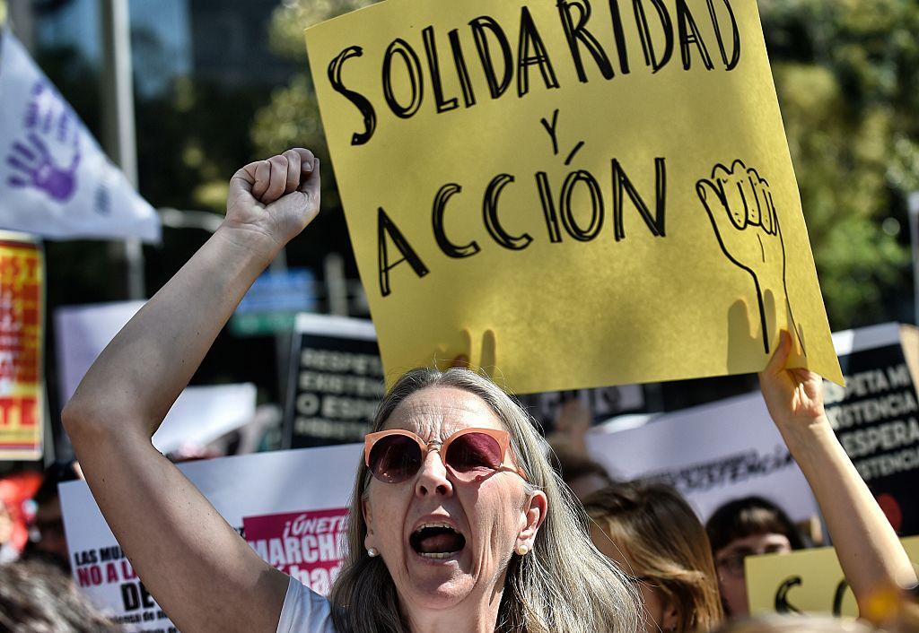 A woman holds a sign reading "Solidarity and action" during the "Women's March" against new US President Donald Trump in Mexico City on Jan.21, 2017. (PEDRO PARDO/AFP/Getty Images)