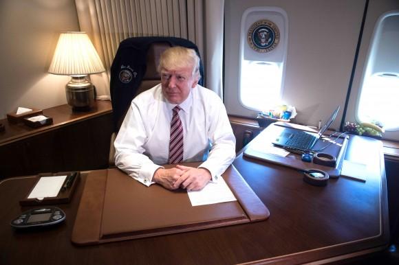 US President Donald Trump poses in his office aboard Air Force One at Andrews Air Force Base in Maryland after he returned from Philadelphia on Jan. 26, 2017. (NICHOLAS KAMM/AFP/Getty Images)