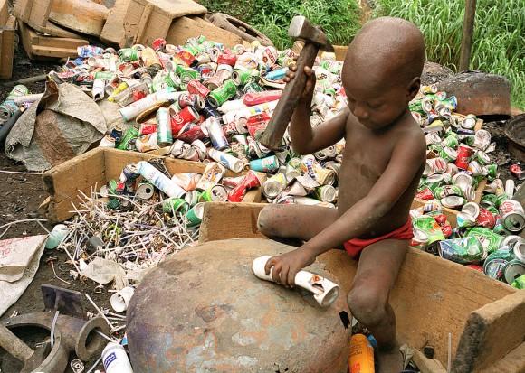 Alpha, 4, hits an aerosol can with a hammer for its aluminium to be reprocessed on Oct. 9, 1999, in Abidjan, Ivory Coast. Scrap aluminum is often used in Africa to make cooking pots, which release lead and other toxins into food, according to a study published in the February 2017 issue of the journal Science of the Total Environment. (Jean-Philippe Ksiazek/AFP/Getty Images)