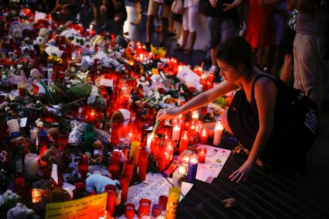 People display flowers, messages and candles to pay tribute to the victims of the Barcelona and Cambrils attacks on the Rambla boulevard in Barcelona on Aug. 22. (PAU BARRENA/AFP/Getty Images)