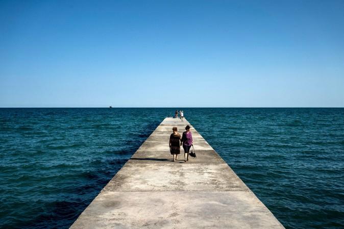 Tourists stroll on a pier in the Black Sea town of Balchik on Aug. 25. (DIMITAR DILKOFF/AFP/Getty Images)