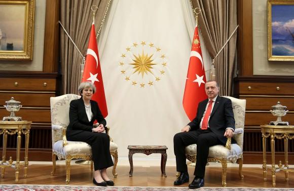 Turkey's President Recep Tayyip Erdogan, right, poses for the photographers with British Prime Minister Theresa May, prior to their meeting at the Presidential Palace in Ankara, Turkey on Jan. 28, 2017. (Pool via AP)