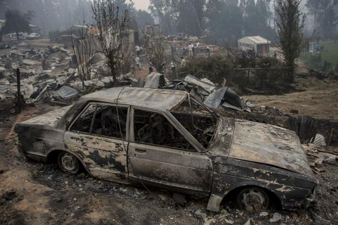 The town of Santa Olga, which was destroyed by a forest fire, 330 km south of Santiago, on Jan. 26.<br/>Six people -- among them four firefighters and two police -- have now been killed battling vast forest fires in central Chile, officials said Wednesday. Multiple blazes have ravaged 238,000 hectares (588,000 acres) and are growing, the National Forestry Corporation said in a statement. / AFP / MARTIN BERNETTI (MARTIN BERNETTI/AFP/Getty Images)